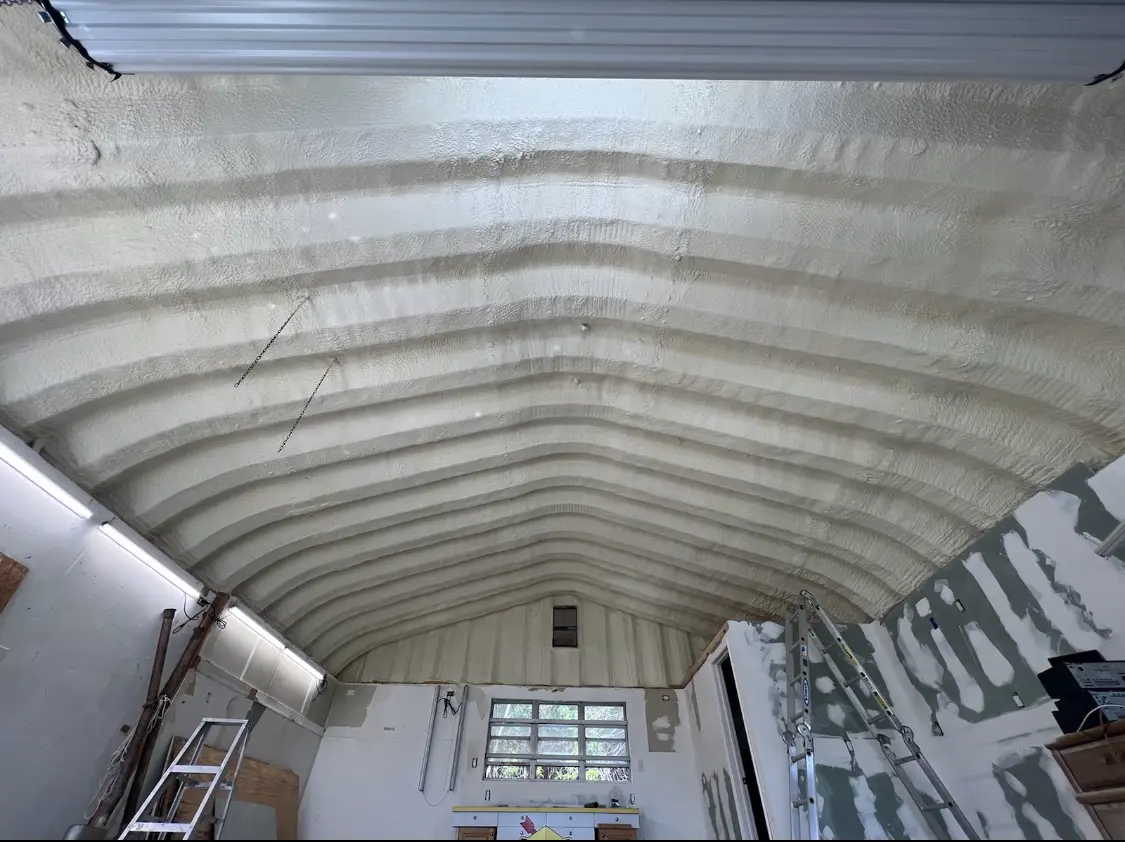 Spray polyurethane foam applied to the underside of a metal roof deck in Williams